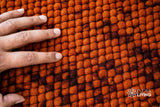 Rust orange wool rug edge and pile detail