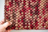 Close-up of beige red wool rug chunky loop pile