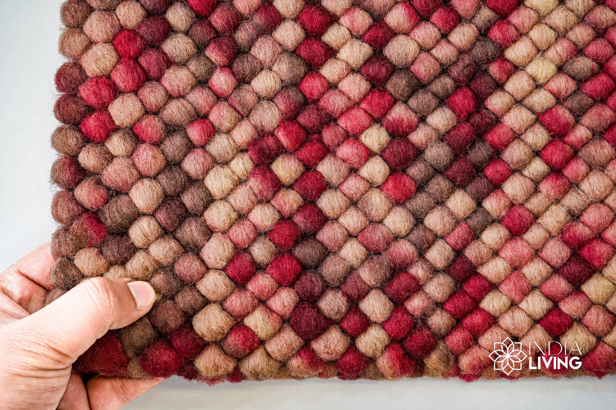Close-up of beige red wool rug chunky loop pile