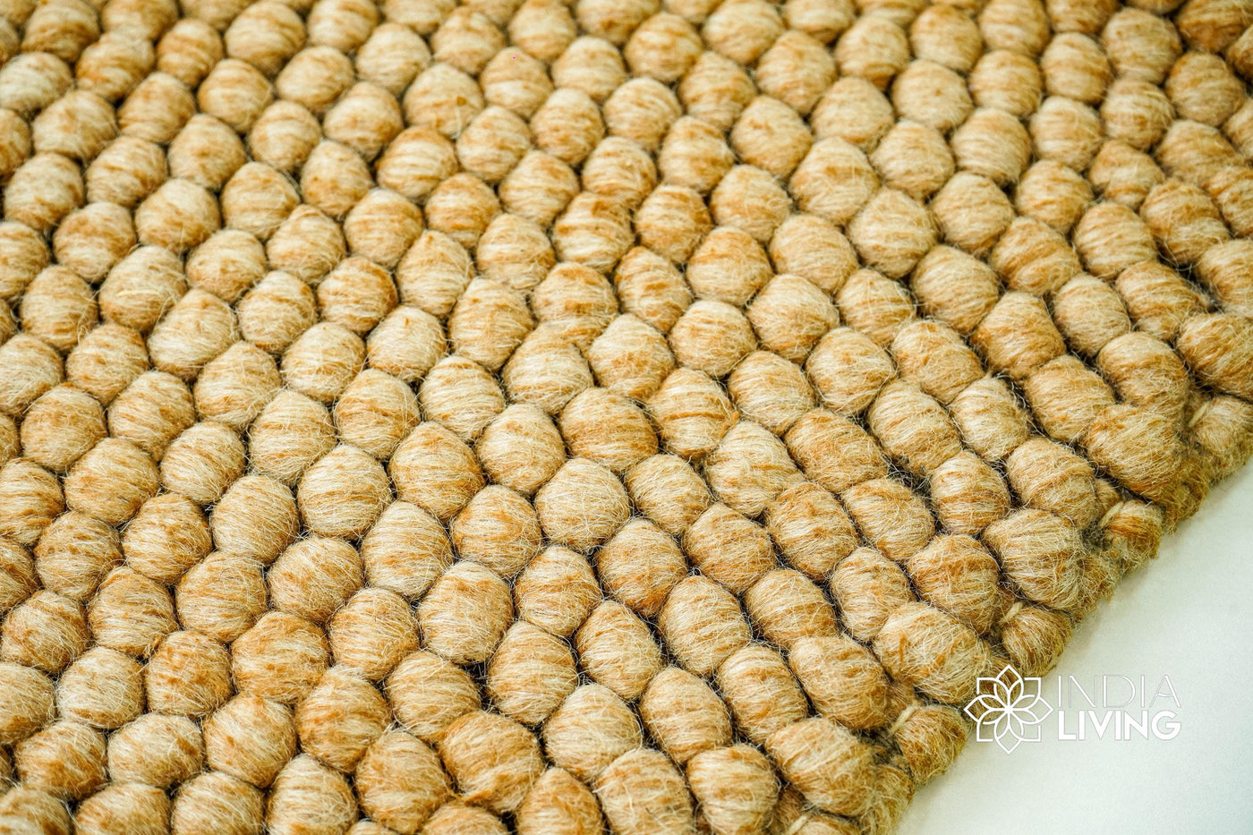 Tan beige chunky wool rug flat lay showing thick pile texture