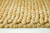 Tan beige wool rug texture close-up
