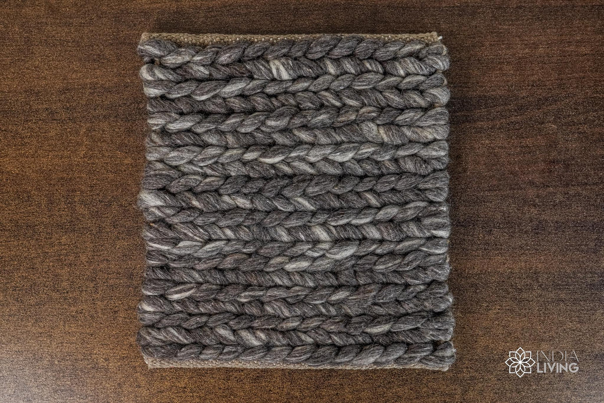 Charcoal grey braided wool rug flat lay showing chunky texture