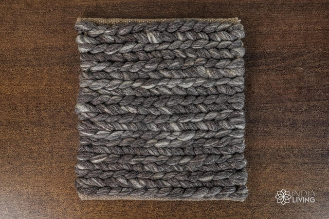 Charcoal grey braided wool rug flat lay showing chunky texture