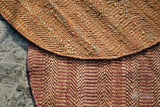 Orange jute round rug in a hallway entryway setting