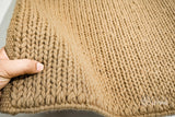 Sumac braided wool rug styled in a living room