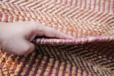 Pink jute round rug in a dining room setting