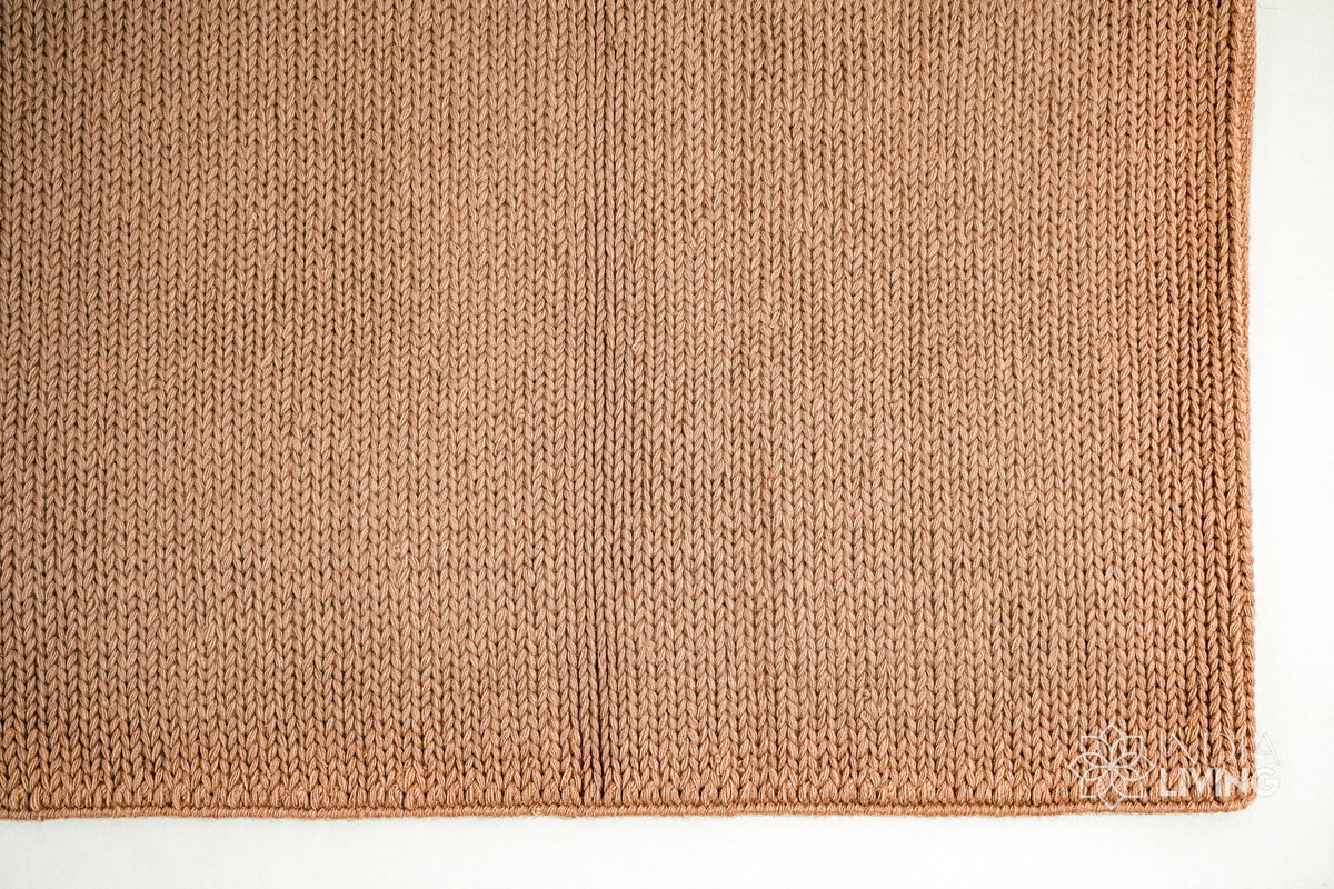 Tan brown wool rug in a bedroom setting