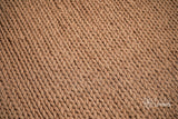 Tan brown wool rug texture close-up