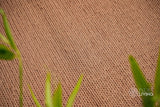 Tan brown wool rug styled in a living room