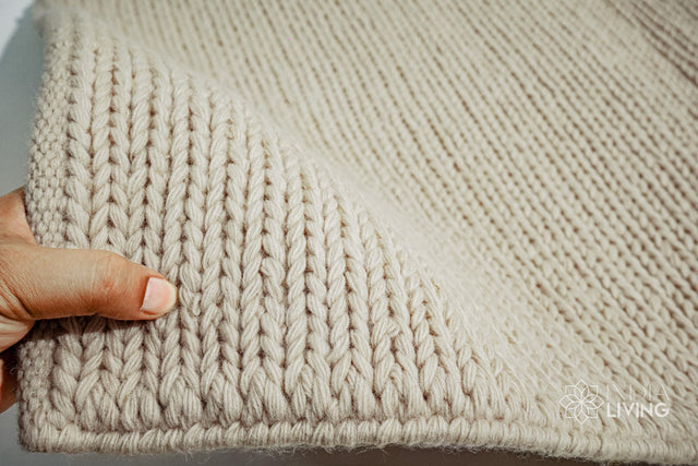 Natural ivory braided wool rug flat lay showing texture