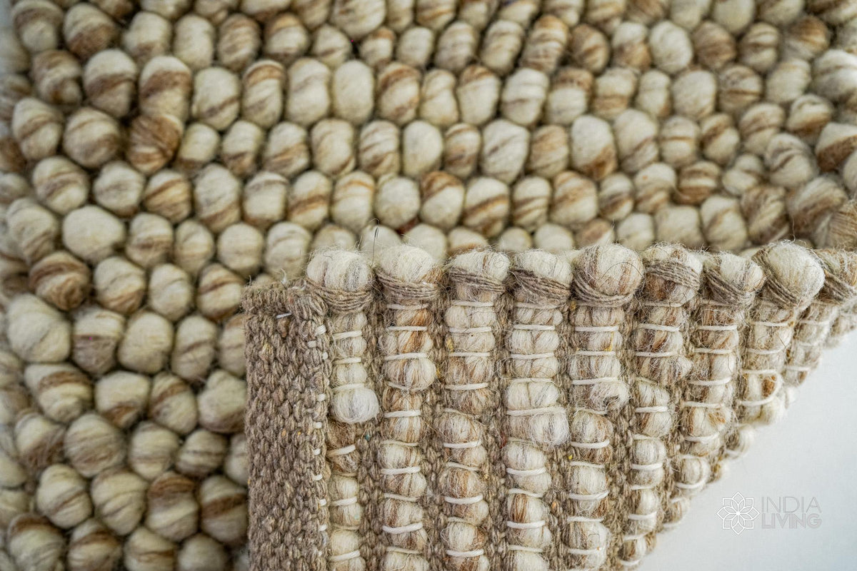 Beige chunky wool rug in a modern nursery