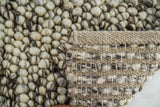 Ivory brown pebble wool rug styled in a living room