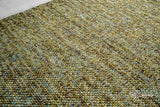 Multi green wool rug in a modern styled room