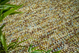 Green wool rug pile texture close-up in natural light