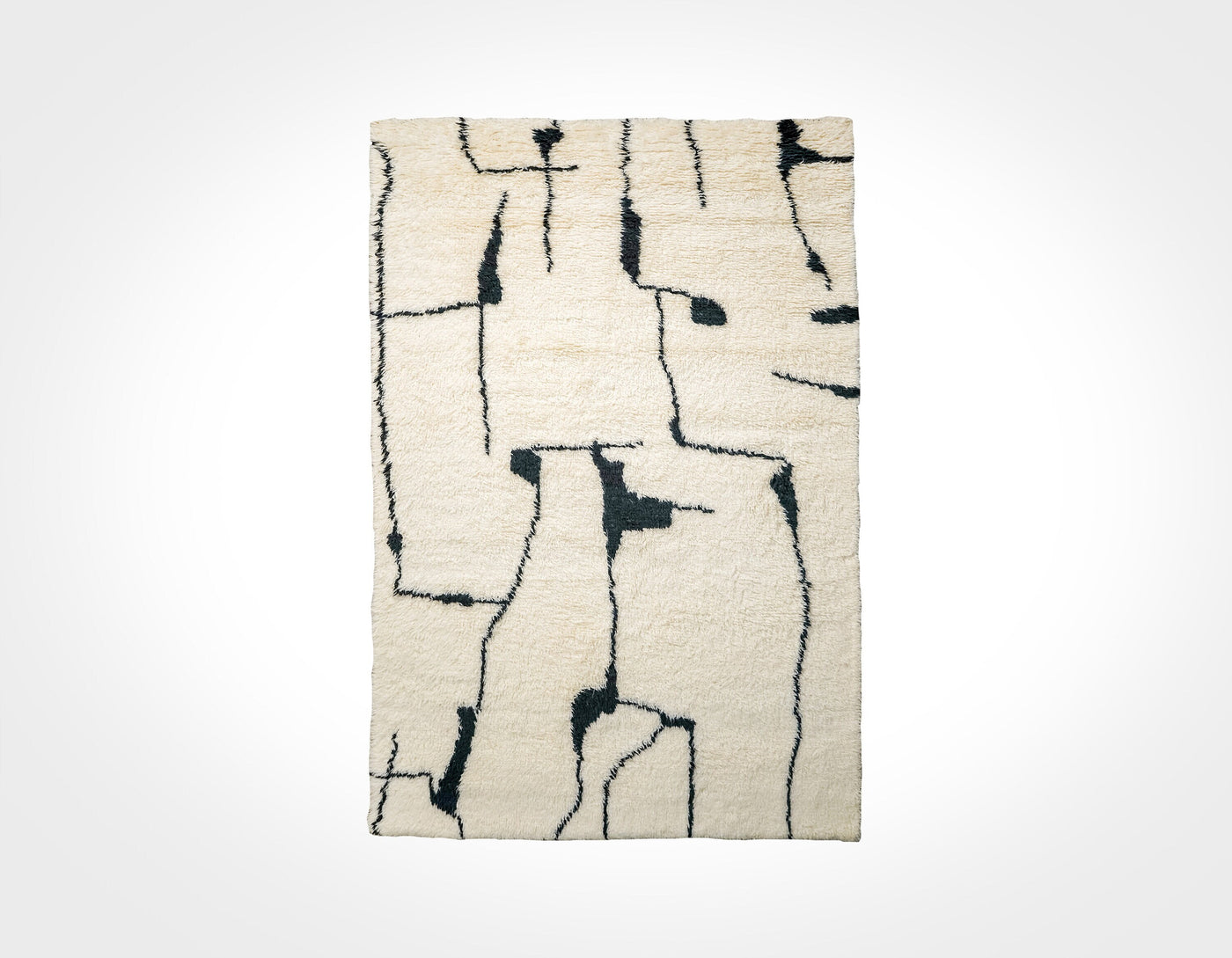 Ivory wool rug with black abstract berber pattern, flat lay