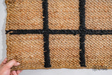 Full view of checkered jute runner on wood floor