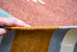Multi-striped rug in a bedroom setting