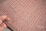 Light pink wool rug placed under furniture