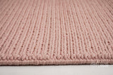 Light pink wool rug corner and edge detail