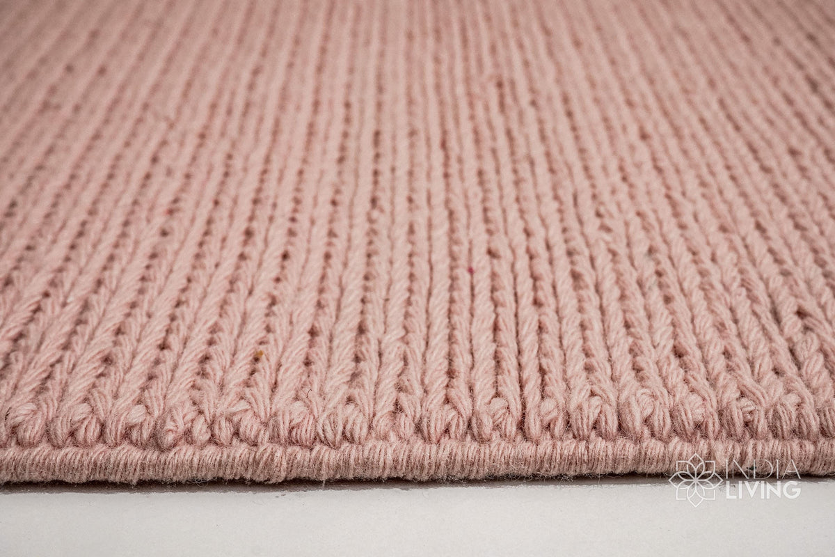 Light pink wool rug corner and edge detail