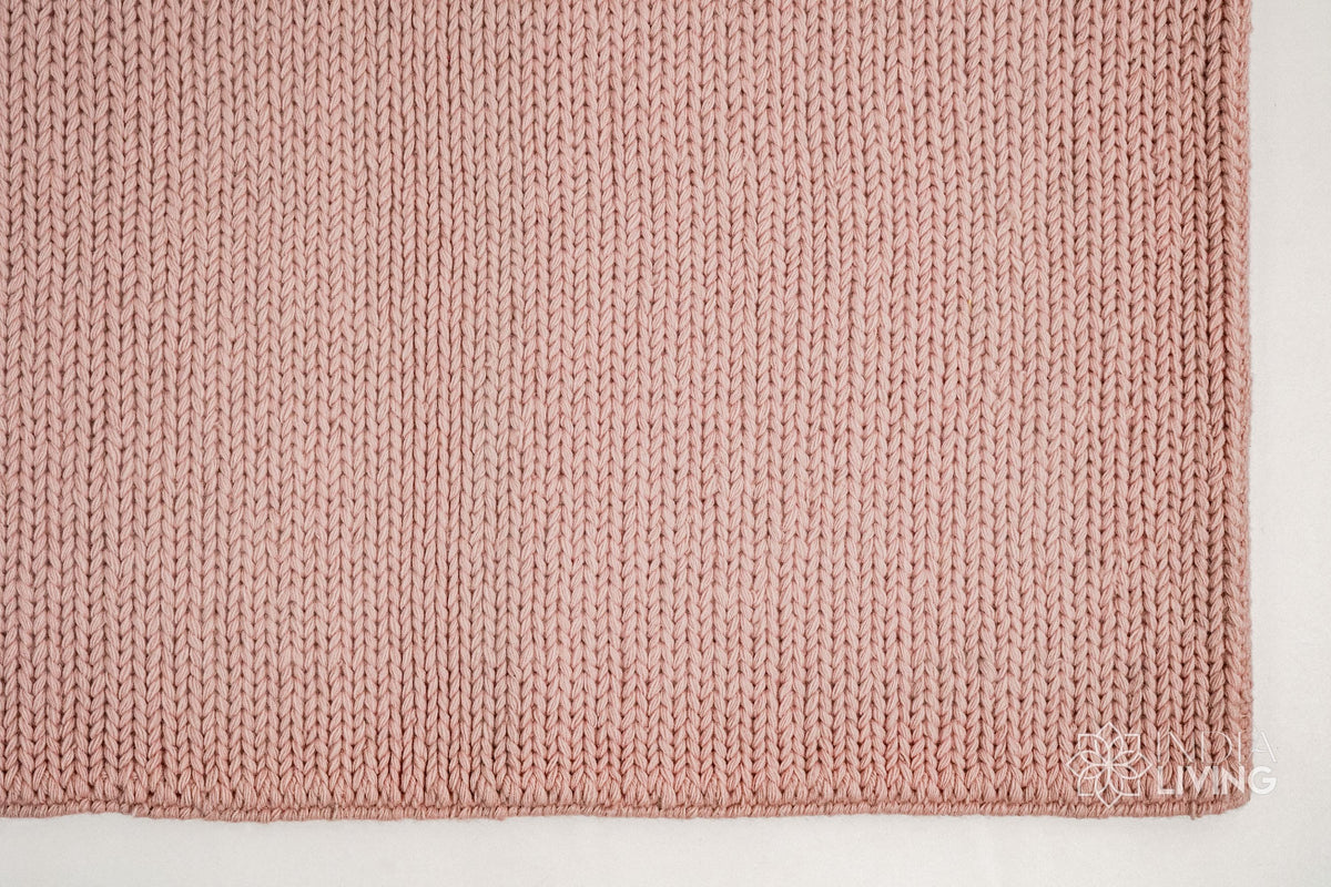 Light pink wool rug in a nursery bedroom setting