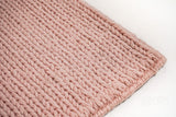 Light pink wool rug texture close-up