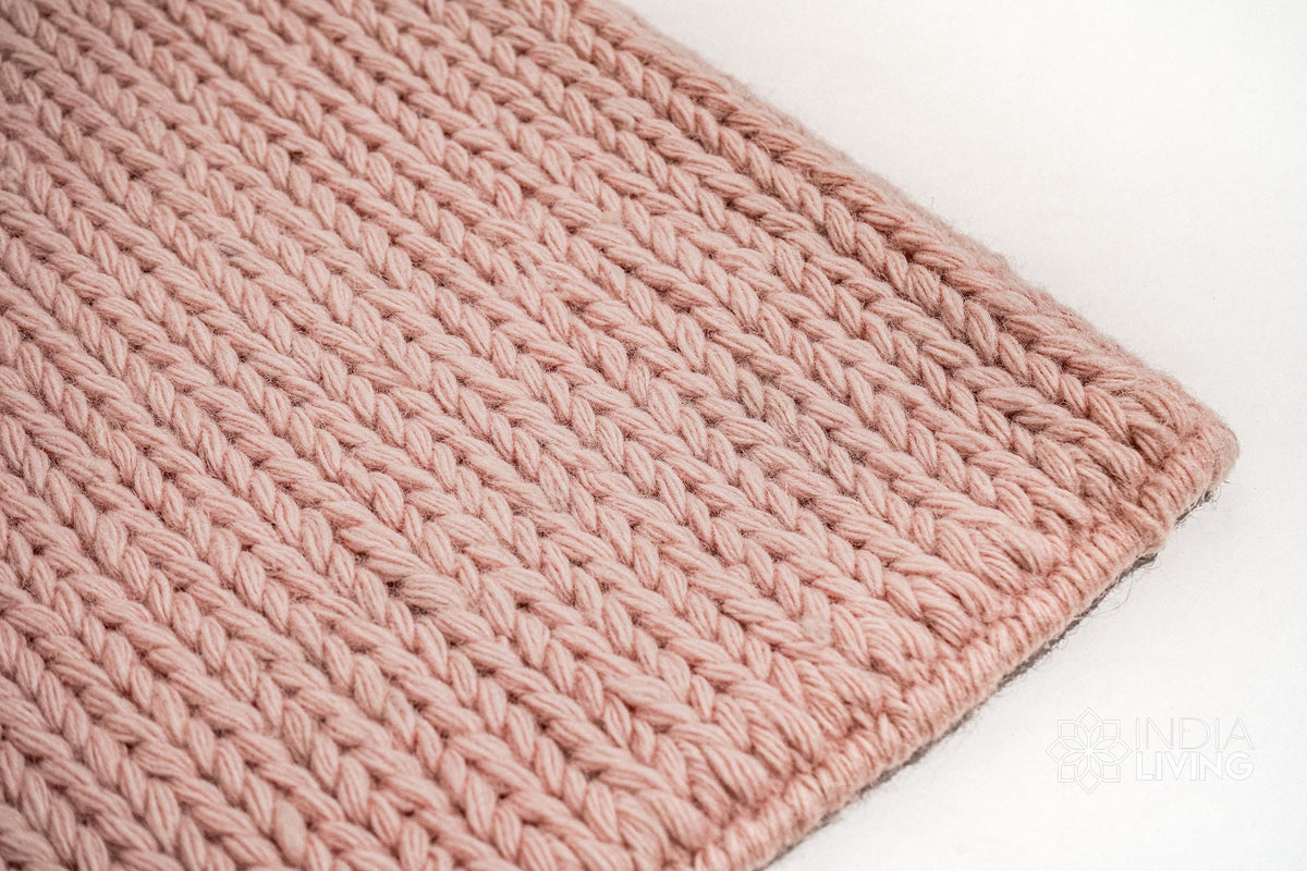 Light pink wool rug texture close-up