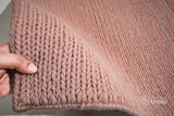 Light pink braided wool rug flat lay showing texture