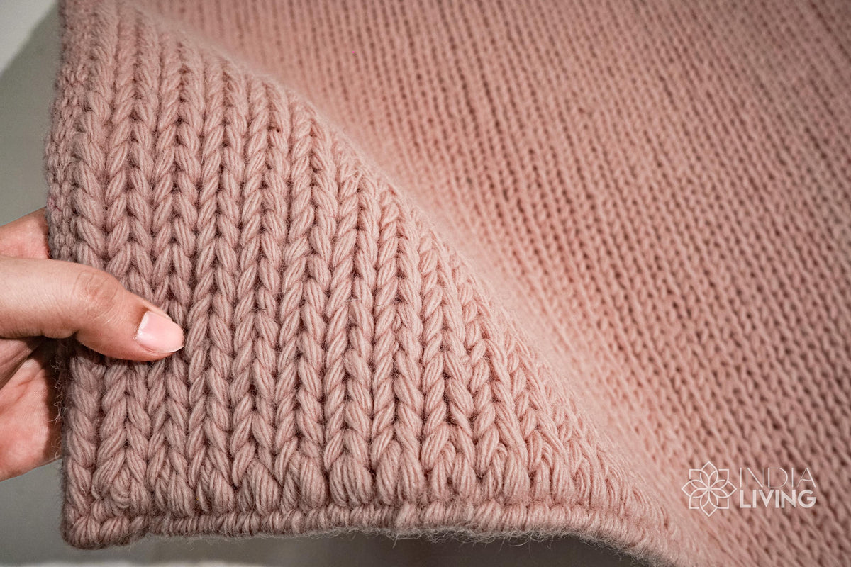 Light pink braided wool rug flat lay showing texture