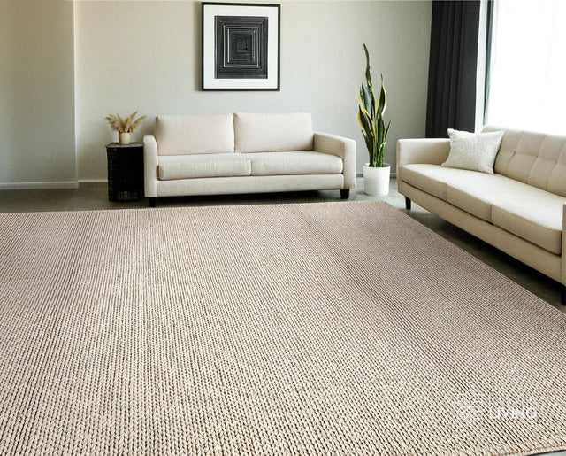 Ivory braided wool rug styled in a minimalist living room
