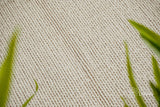 Ivory wool rug in a Scandinavian bedroom setting