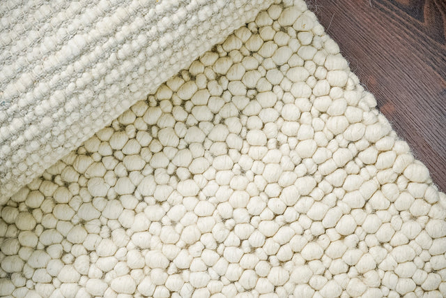 Close-up of ivory chunky pebble wool texture