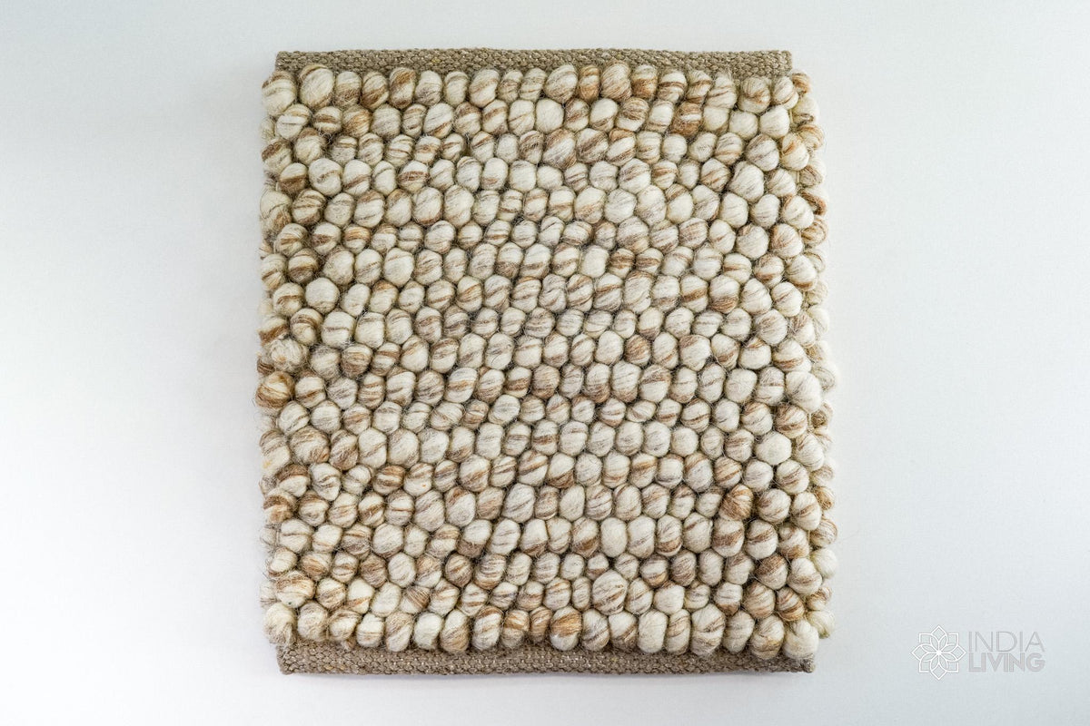 Close-up of chunky wool loop pile texture in natural beige