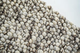 Corner detail of ivory brown pebble wool rug