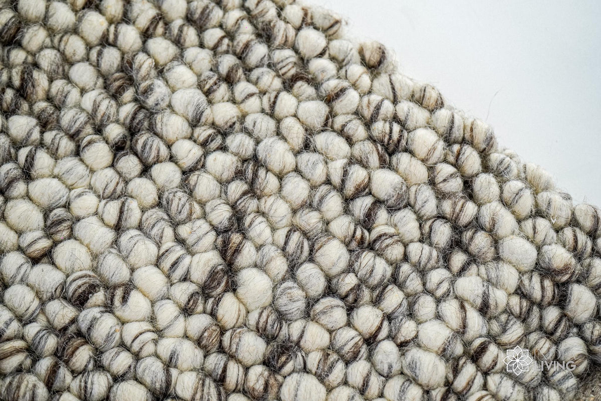 Corner detail of ivory brown pebble wool rug