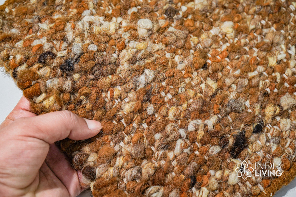 Rust brown wool rug styled in a living room