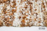 Full view of ivory brown textured wool rug on floor