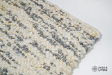 Full view of ivory grey textured wool rug on floor
