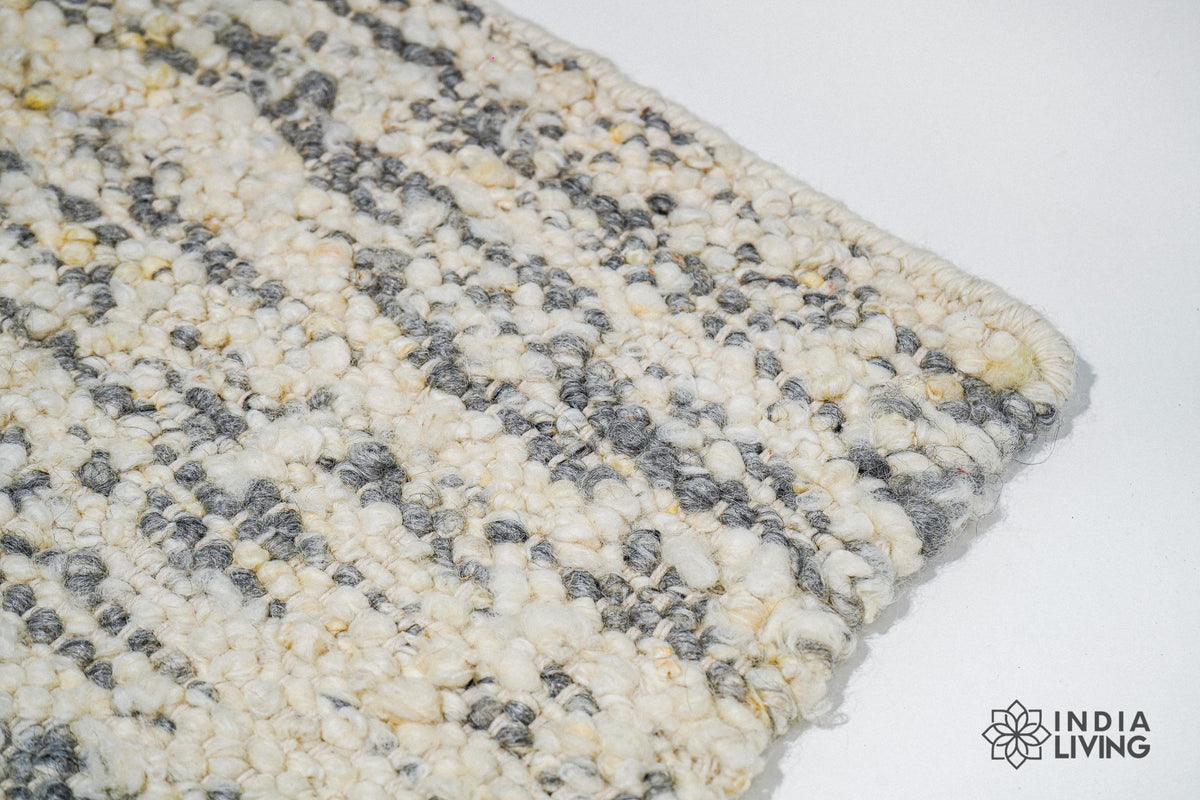 Full view of ivory grey textured wool rug on floor