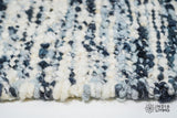Ivory blue wool rug in a minimalist bedroom