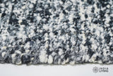 Ivory black wool rug placed under a coffee table