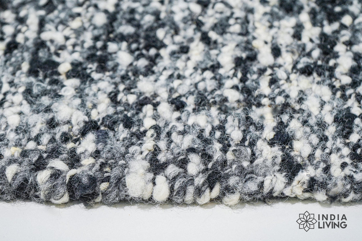 Ivory black wool rug placed under a coffee table