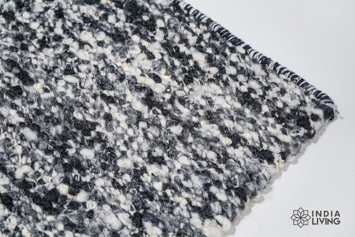 Ivory black wool rug in a bohemian bedroom