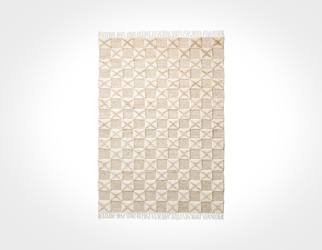 May include: A beige and white woven rug with a geometric pattern. The rug has a fringe border.