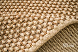 Beige wool rug styled in a living room