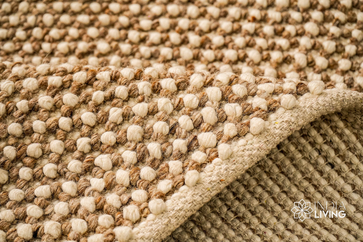 Beige wool rug styled in a living room