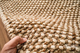 Overhead view of beige chunky wool rug