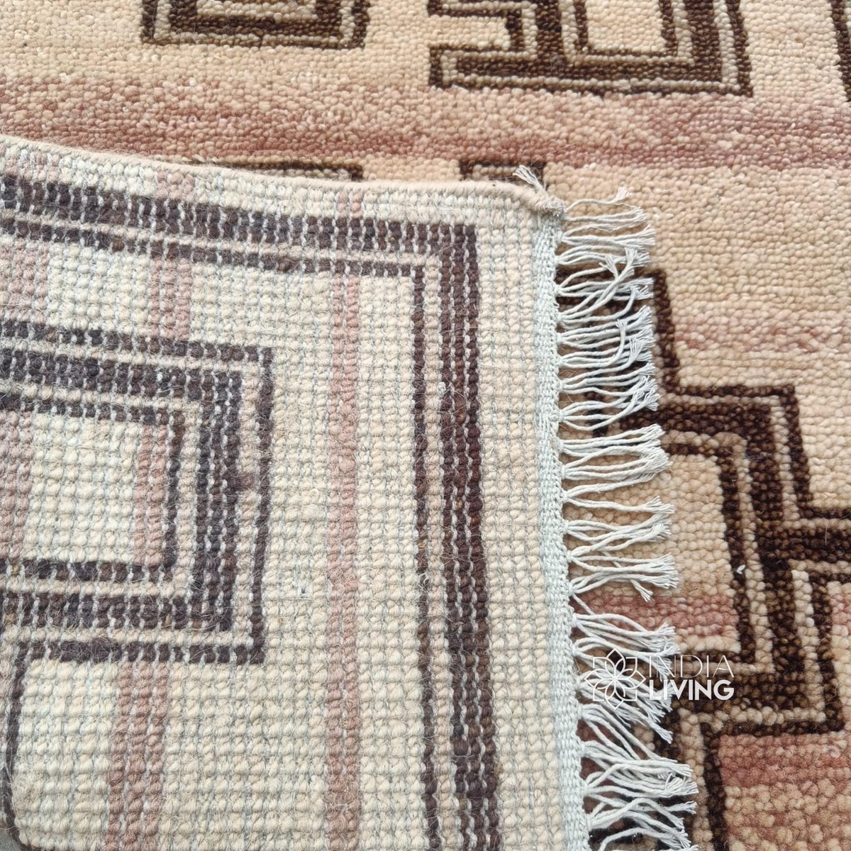 Corner detail of hand-knotted geometric wool rug