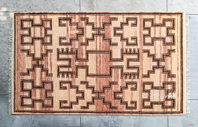 Hand-knotted geometric wool rug styled in a living room