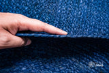 Oval rug corner detail showing braided edge